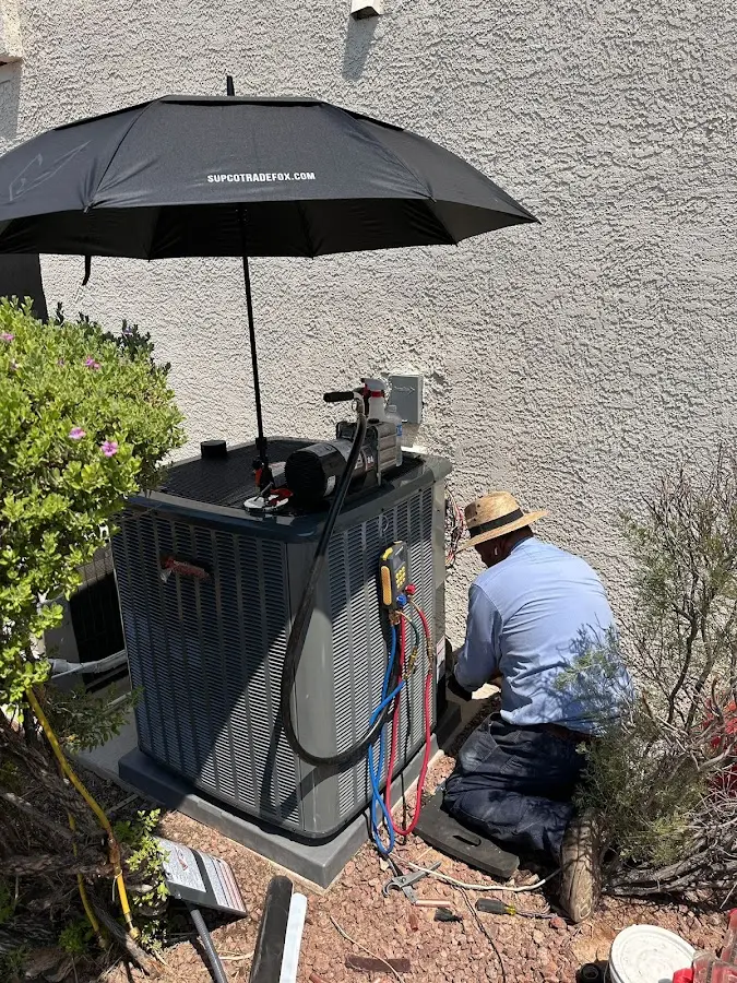 HVAC technician performing outdoor AC maintenance in Philadelphia
